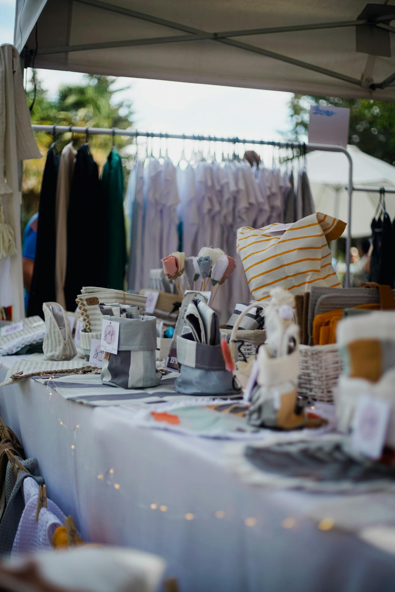 Colorful display of handmade items at an outdoor market stall showcasing artisanal craftsmanship.